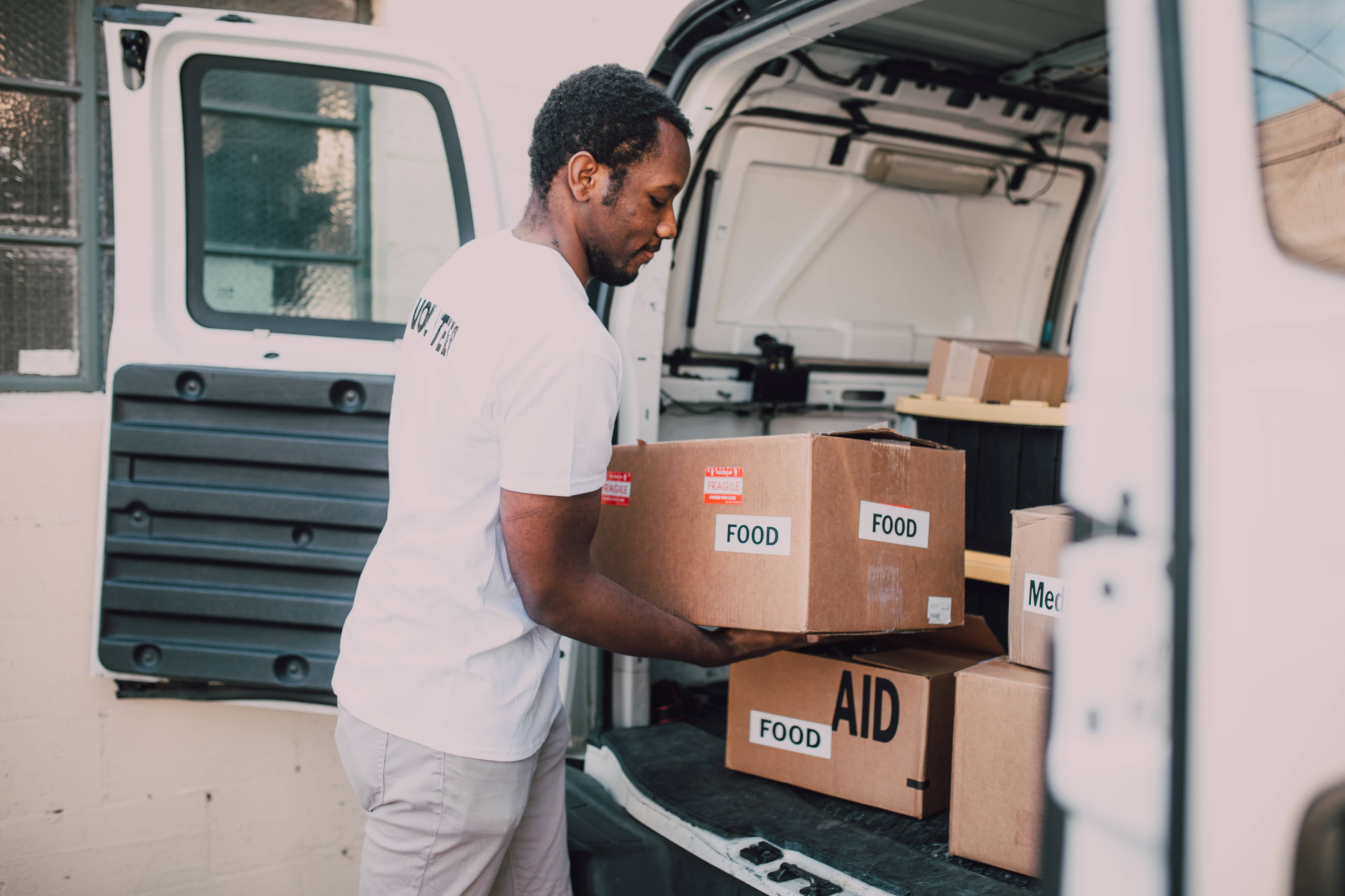 Volunteer stocking food aid into a van